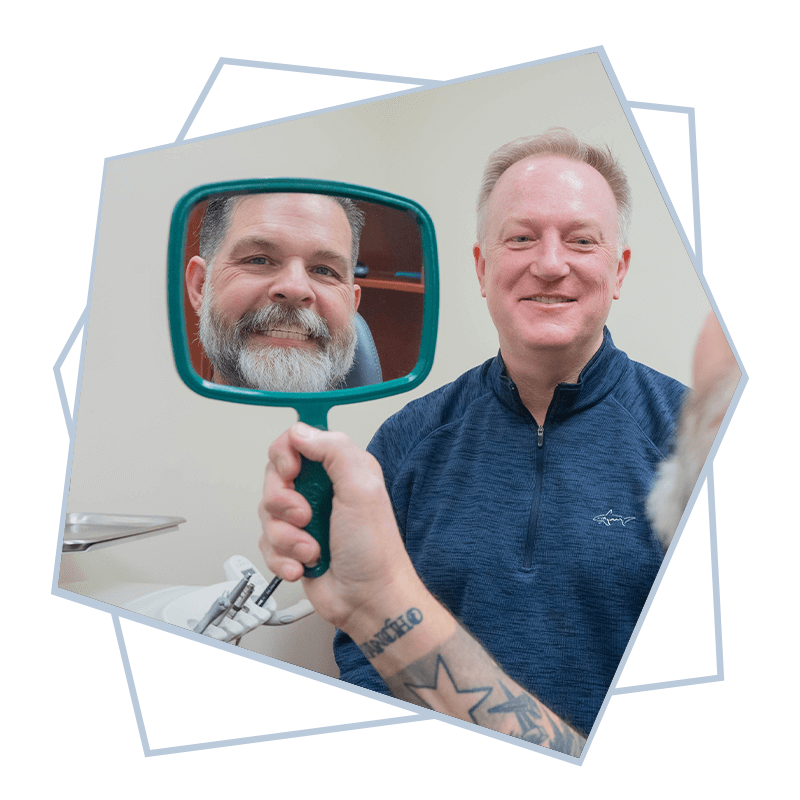 patient smiling into mirror