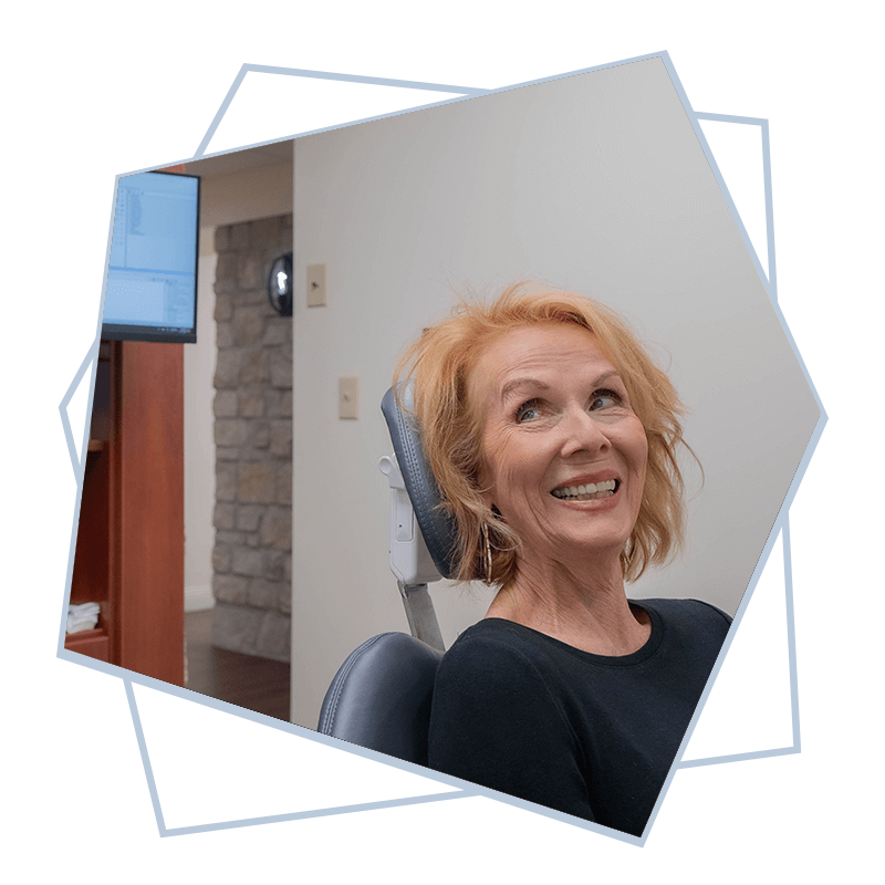 woman in dental office talking t o doctor