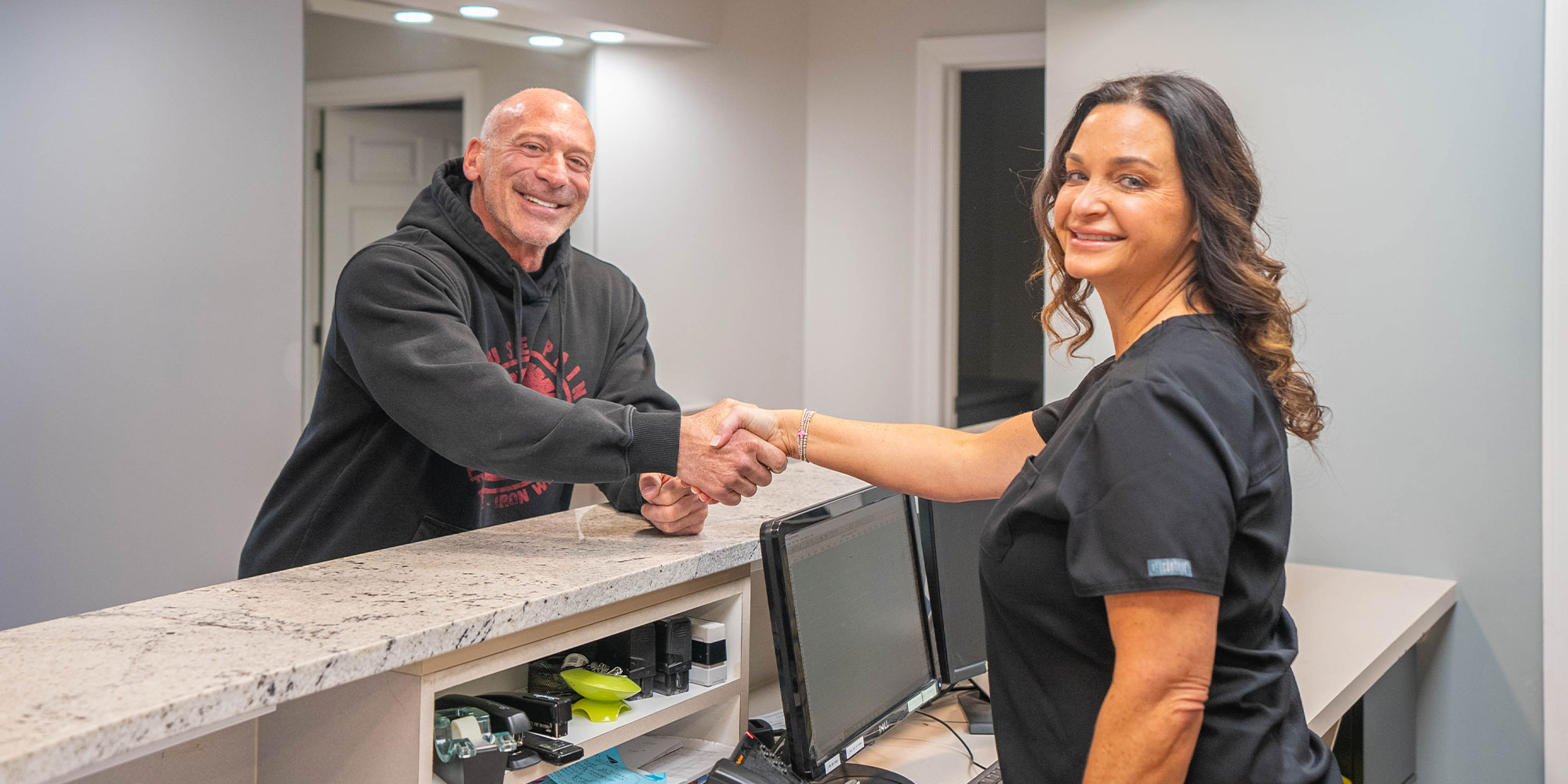 team member greeting patient into the dental office