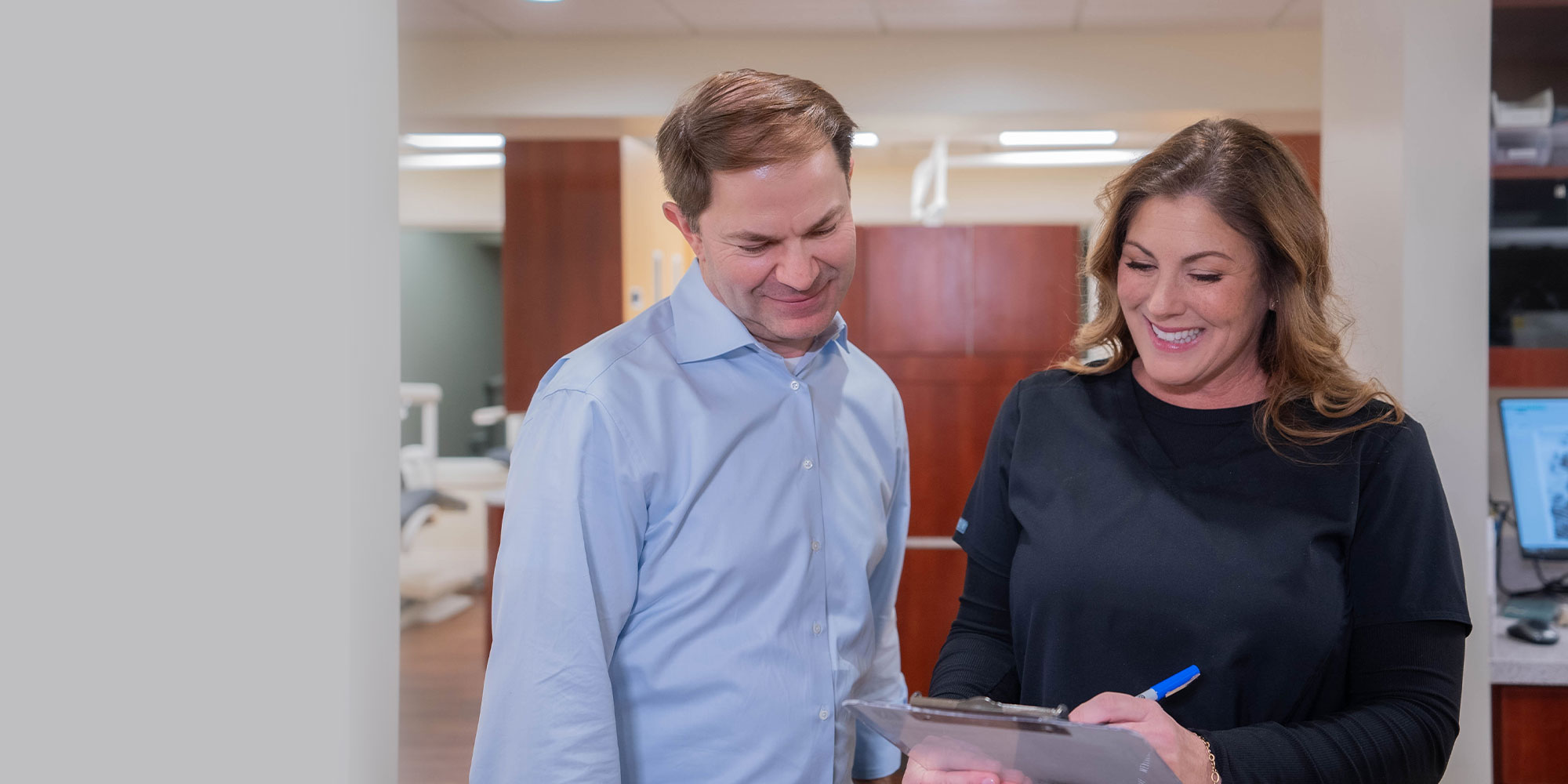 doctor going over insurance with team member