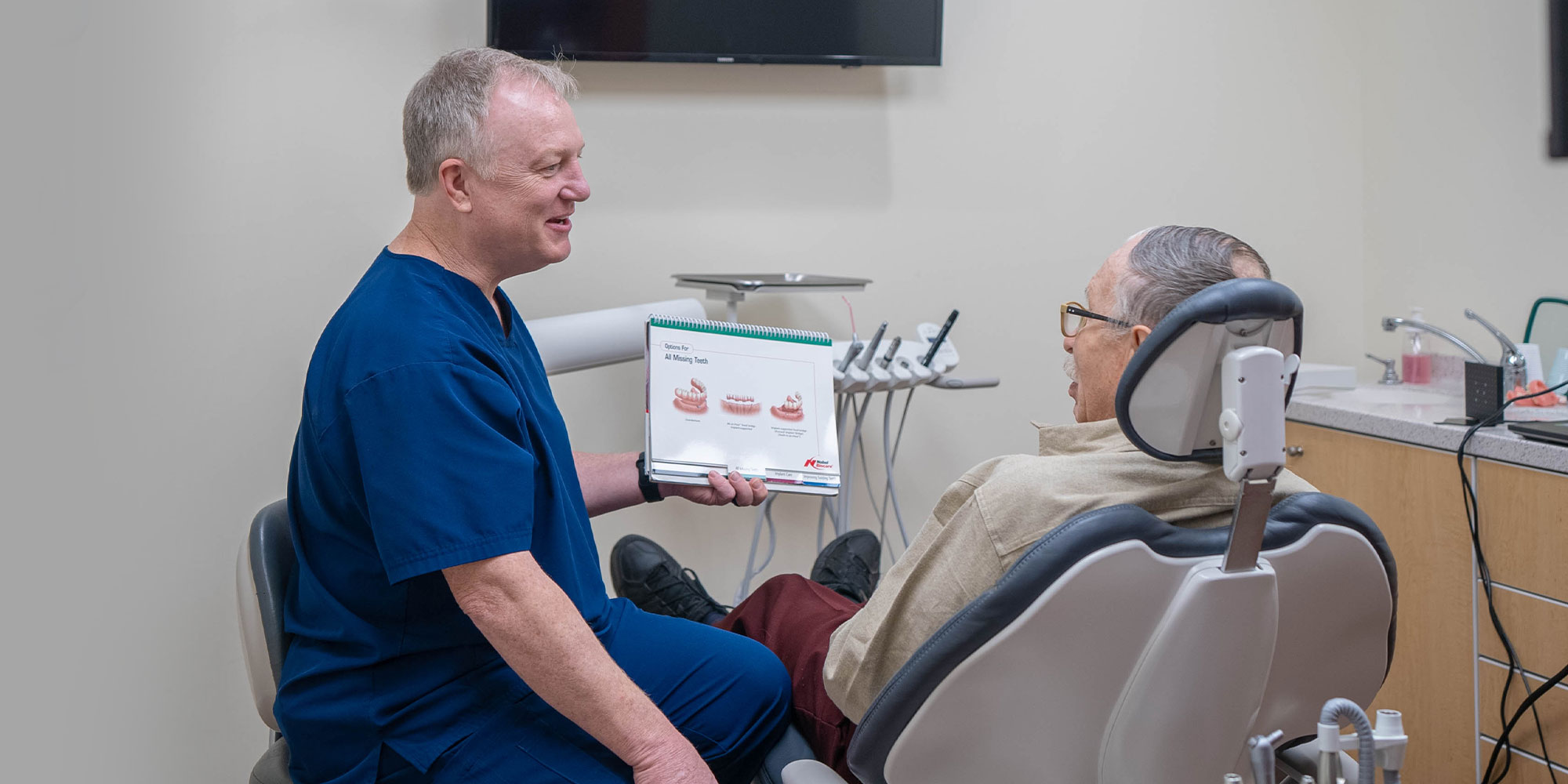 doctor going over different types of dental implants with patient